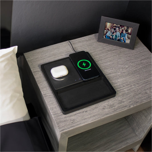 A wireless charging pad with two charging coils and separate charging ports for USB-C and USB-A, with an iPhone and AirPods on it indicating the MagSafe technology.