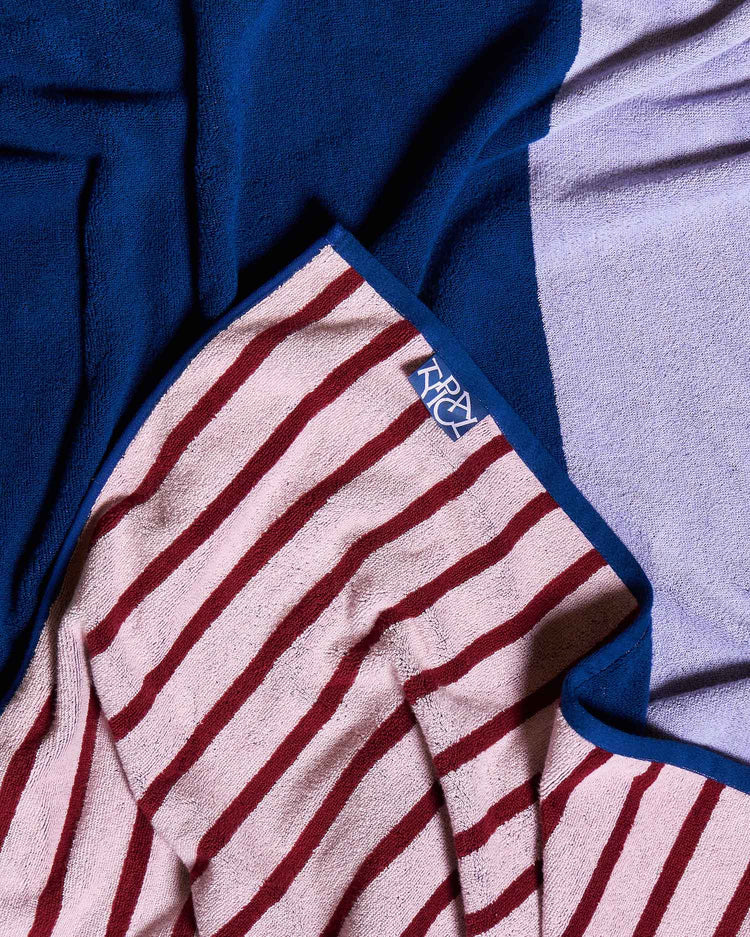 Striped towel with a logo on a blue and gray background