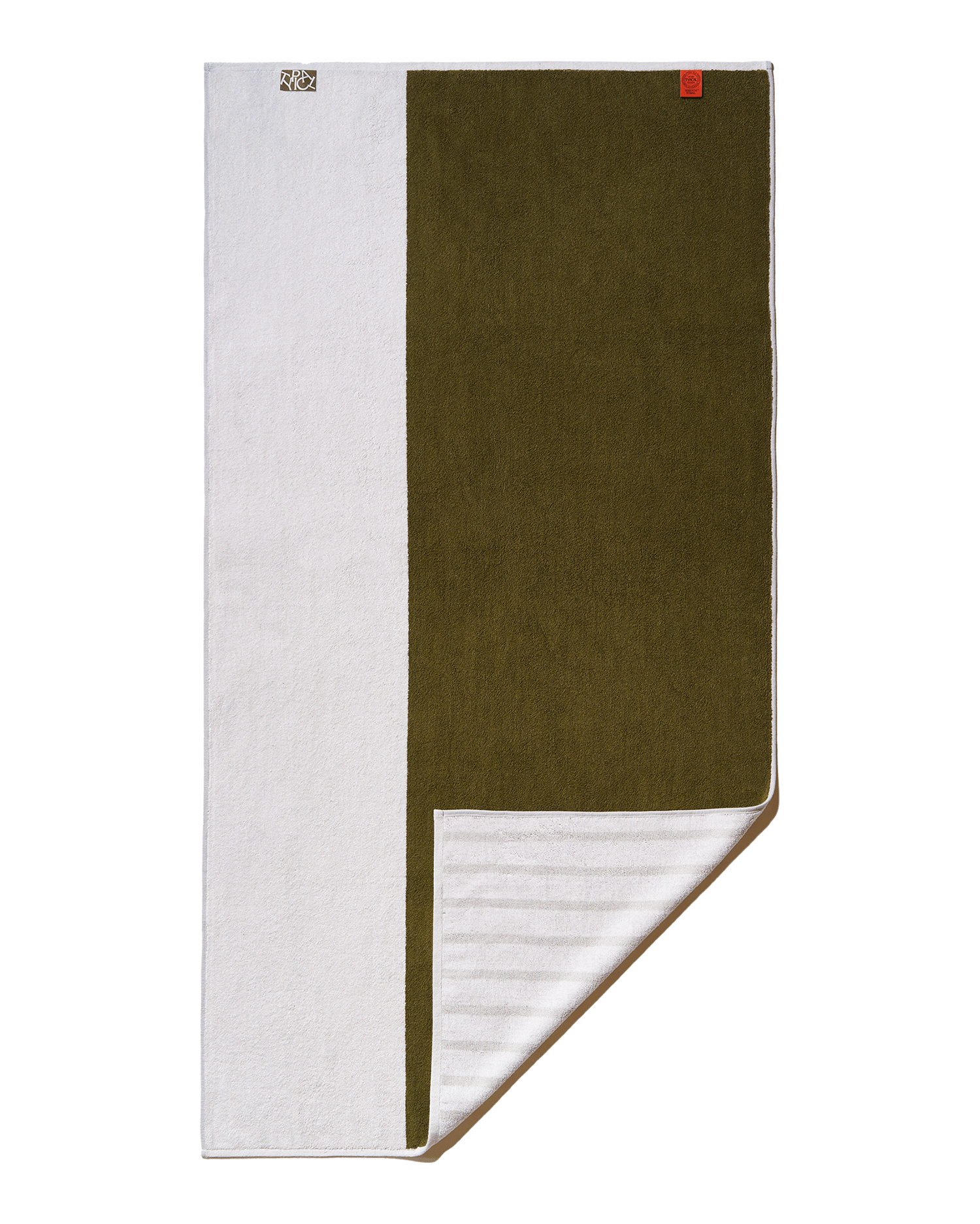 Folded towel with green and white sections on a white background