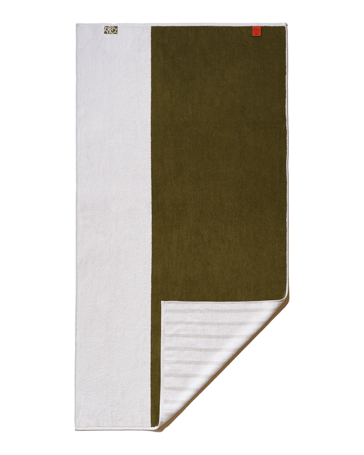 Folded towel with green and white sections on a white background