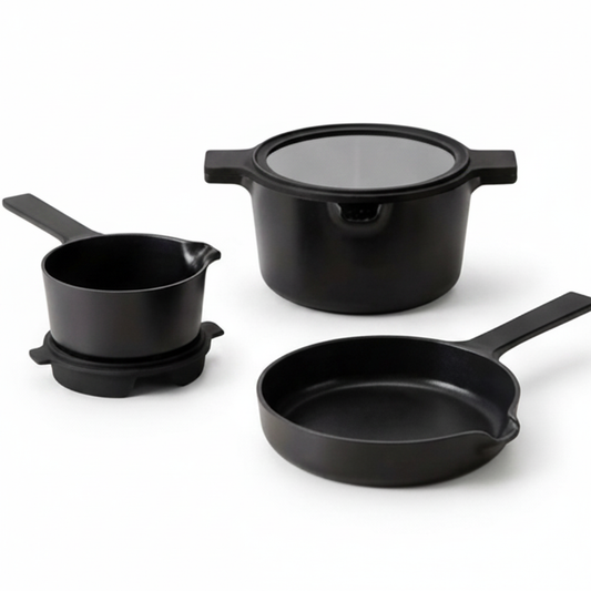 Set of black cookware including a pot, saucepan, and frying pan on a white background
